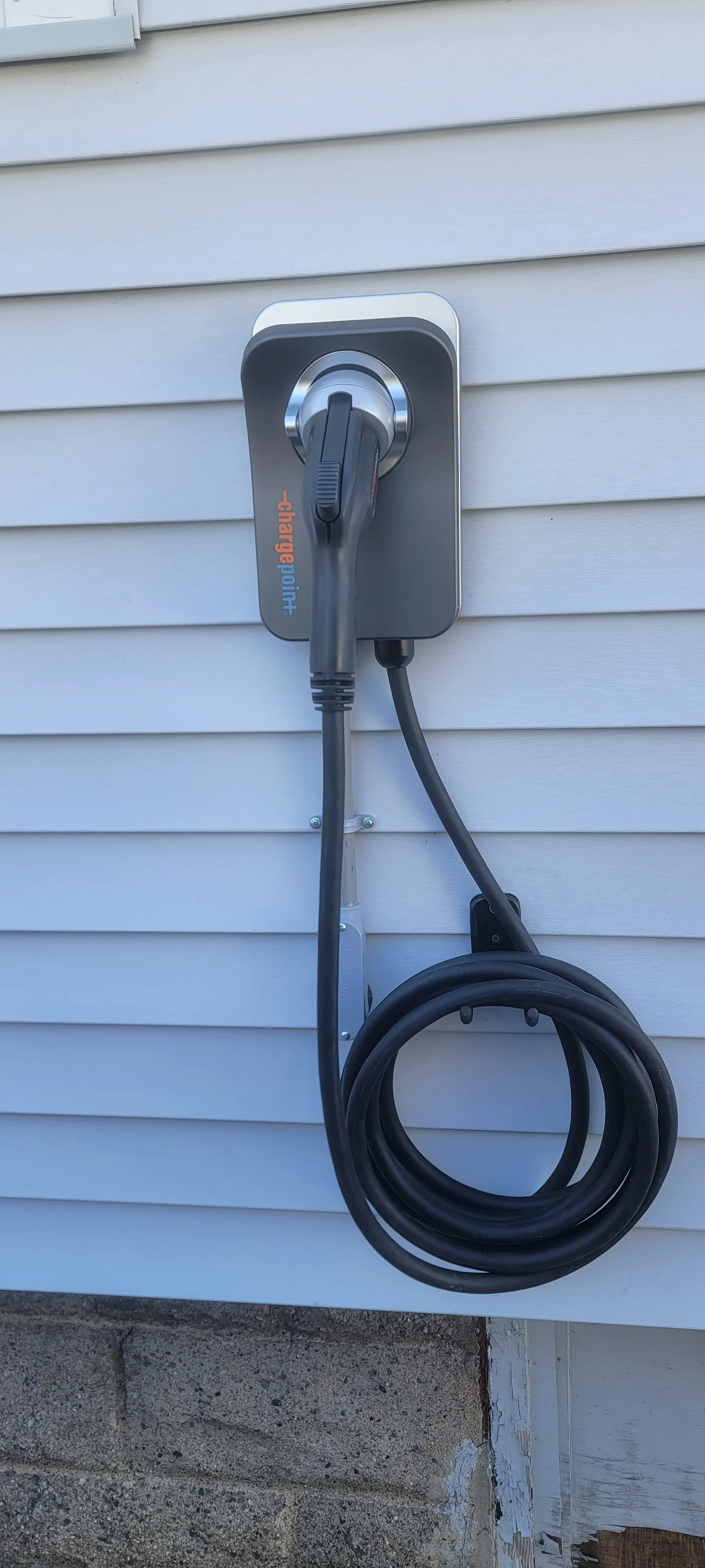 ChargePoint EV charger mounted on the exterior siding of a home