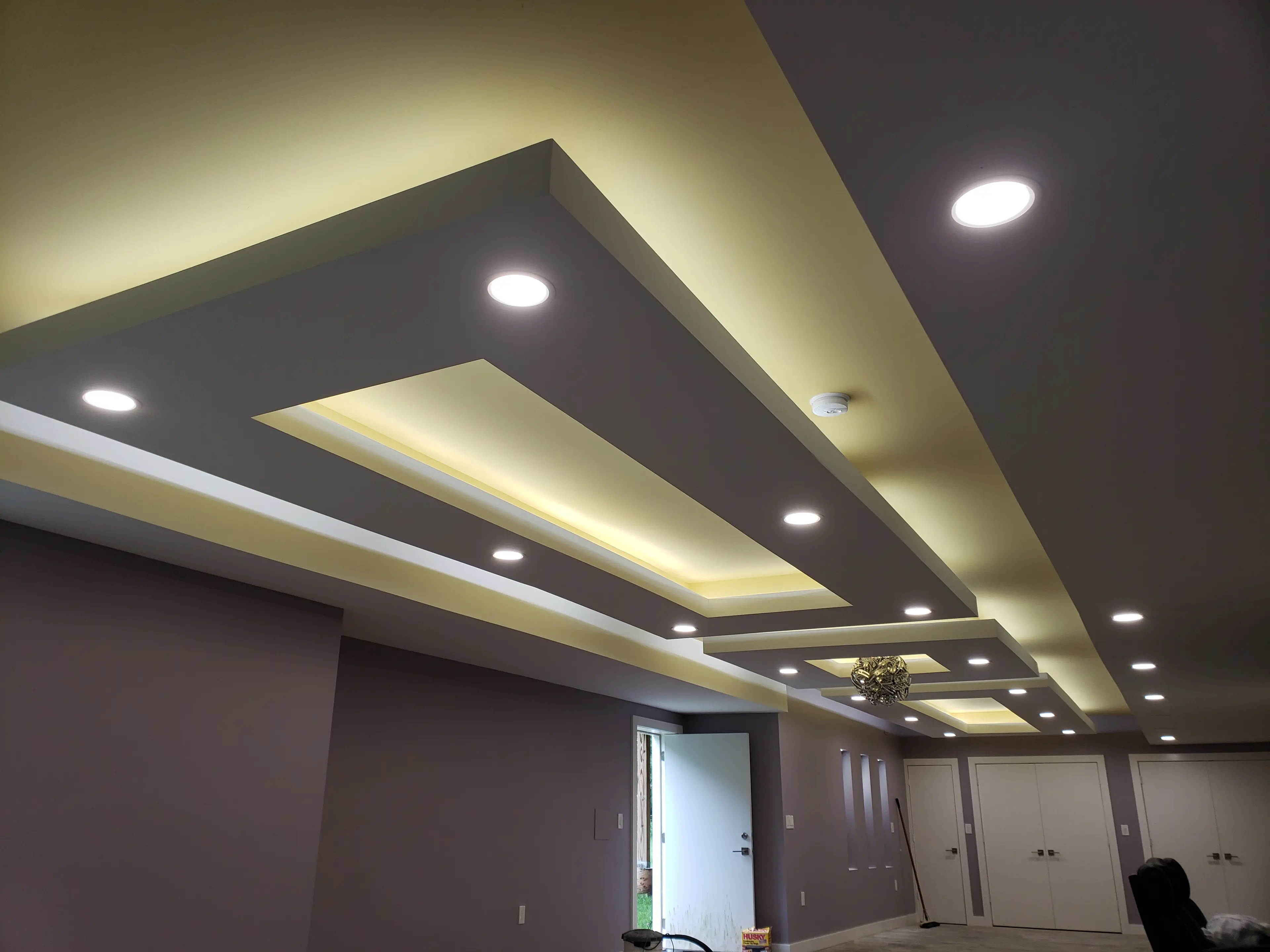 Recessed lighting installed along a cove ceiling in a residential room