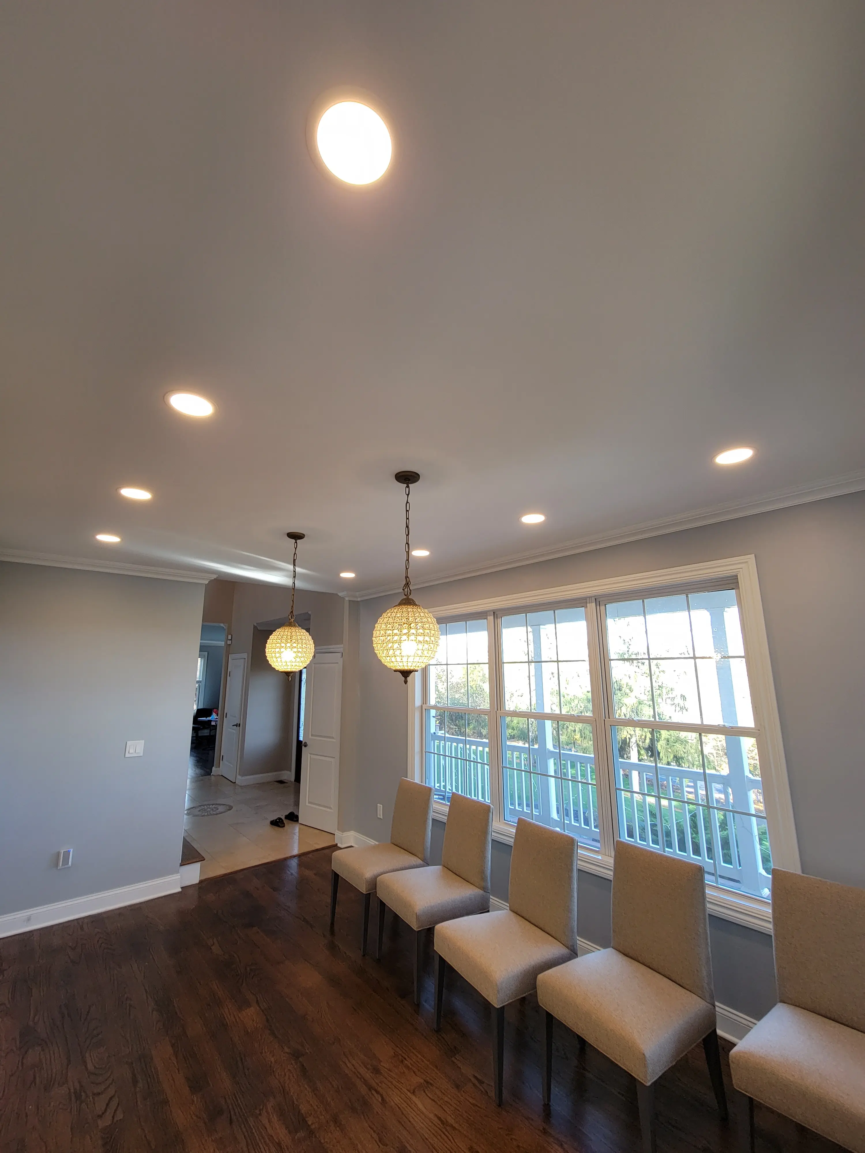 Finished dining area with recessed ceiling lighting and two hanging pendant fixtures