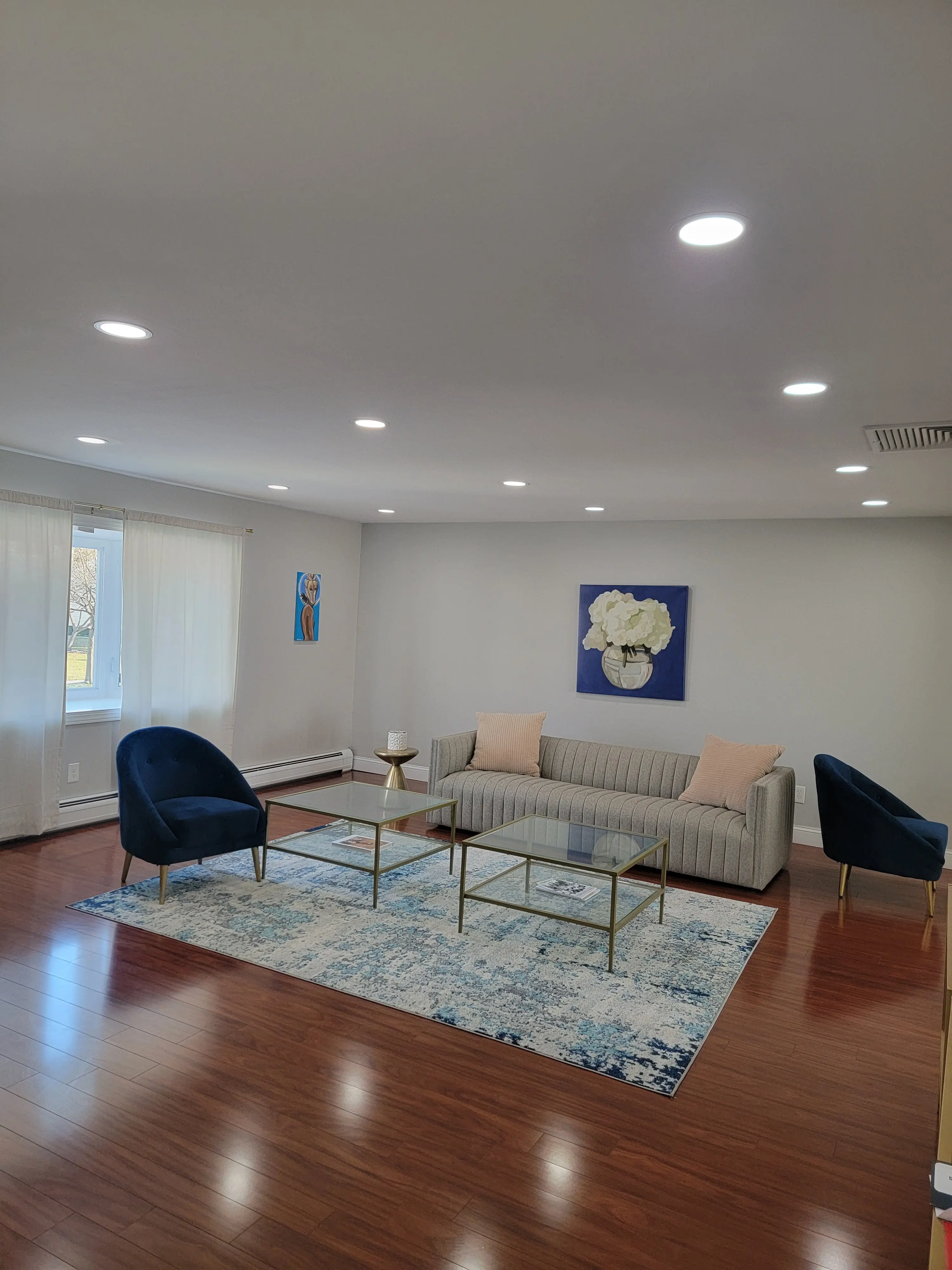 Large finished living room with recessed ceiling lighting distributed across the ceiling