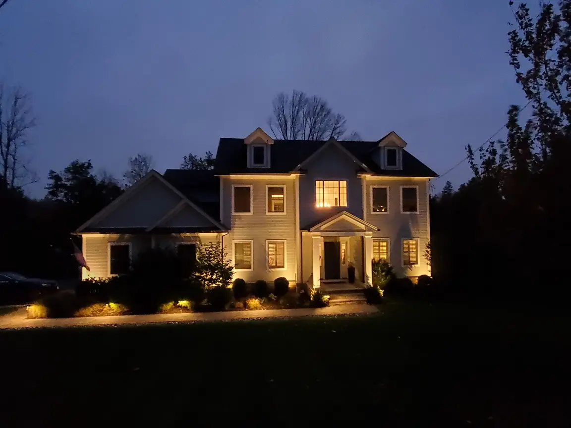 Residential landscape lighting highlighting the front of a home