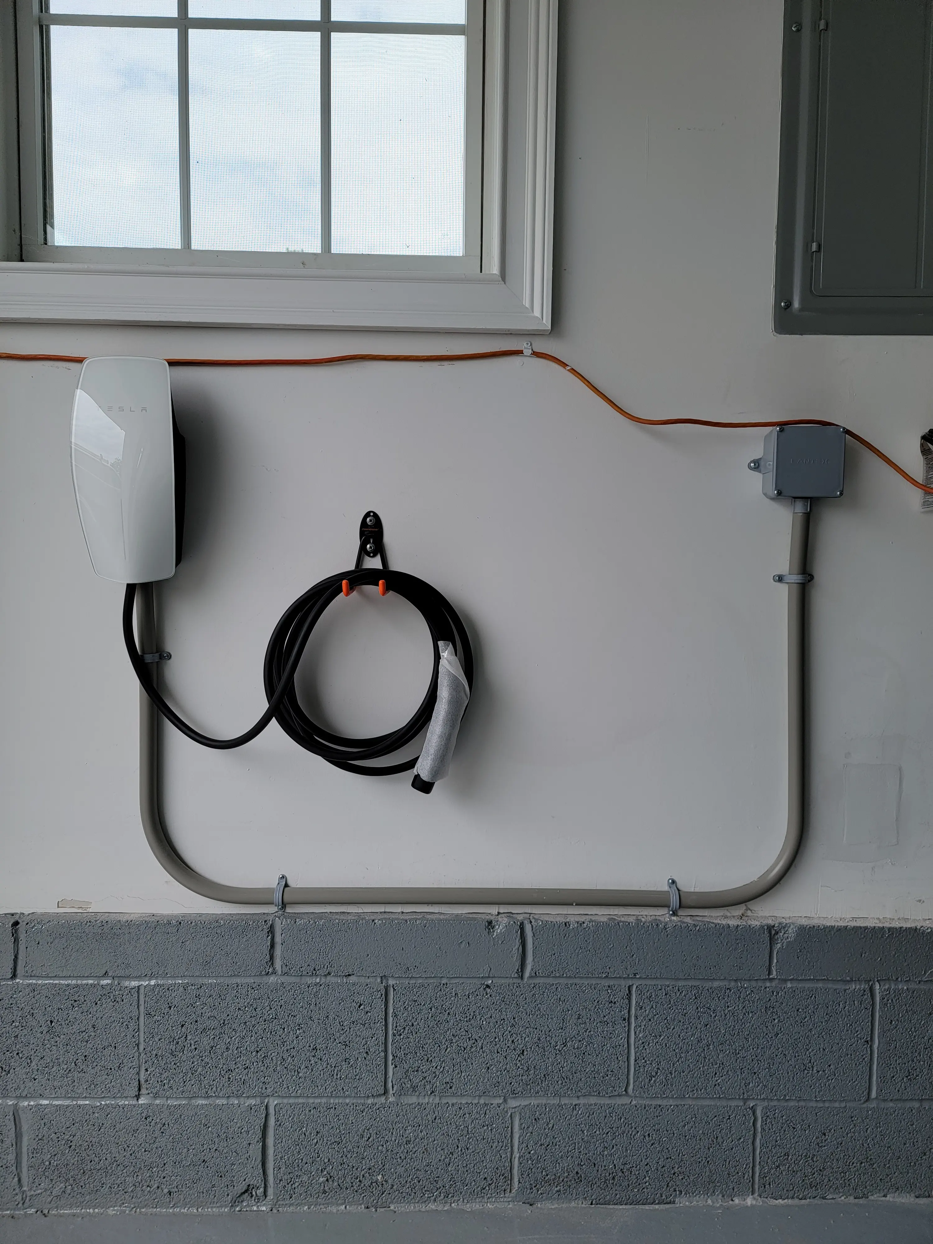 Tesla Wall Connector EV charger installed in a residential garage